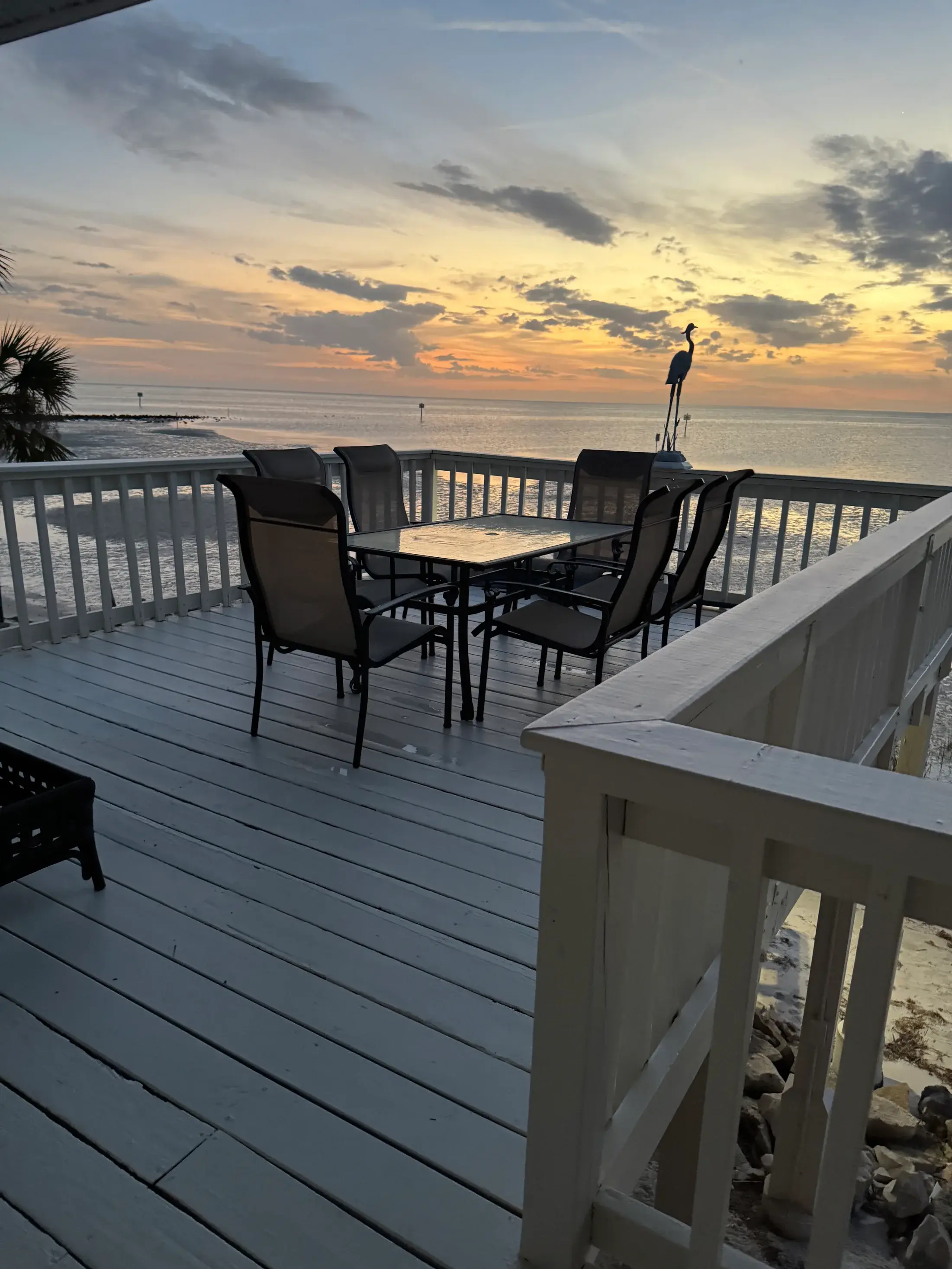 Sunset view from the private waterfront deck at Come Sail Away Suite.